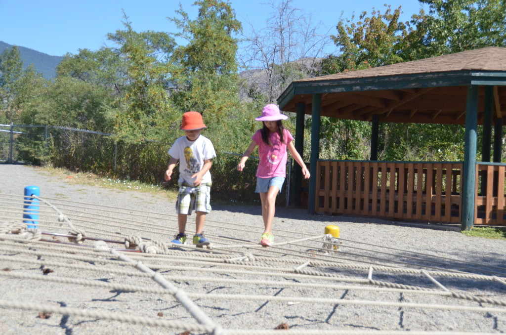 Play area at the zoo. Trying to balance on the rope